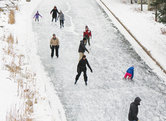 Skaters on the ice at Centennial Lakes Park.