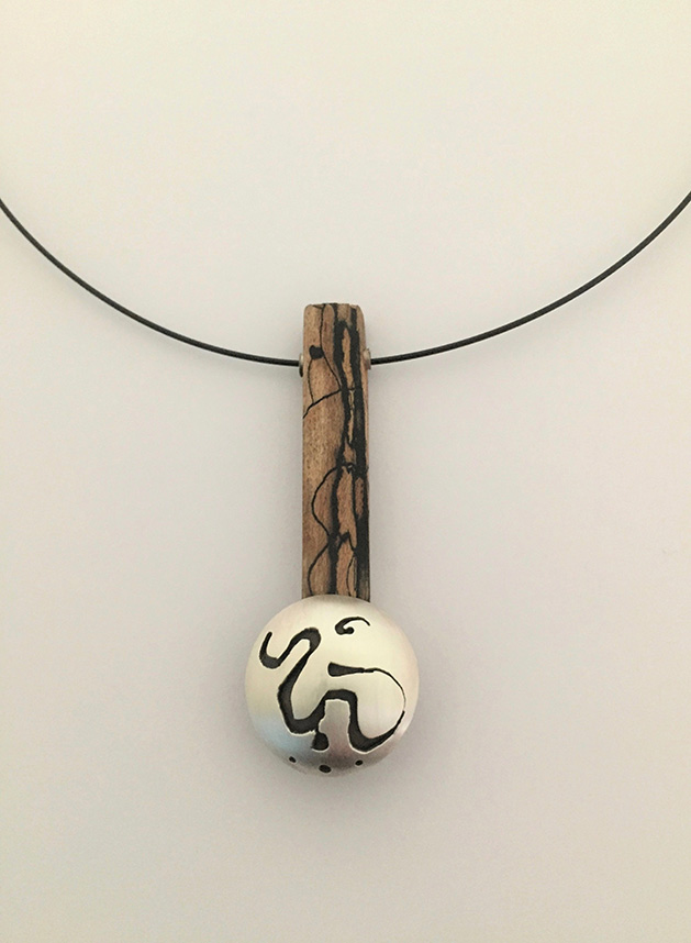 Metal and wood pendant necklace.