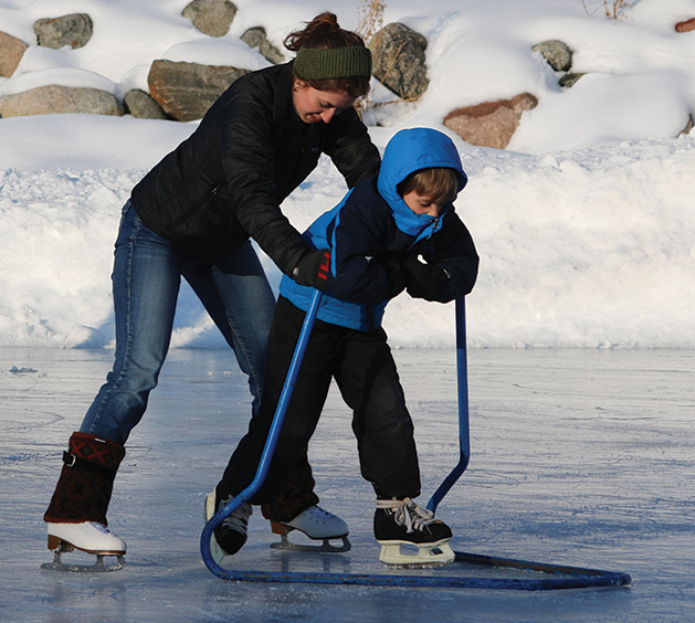 A child learning to ice skate at Centennial Lakes Park in Edina