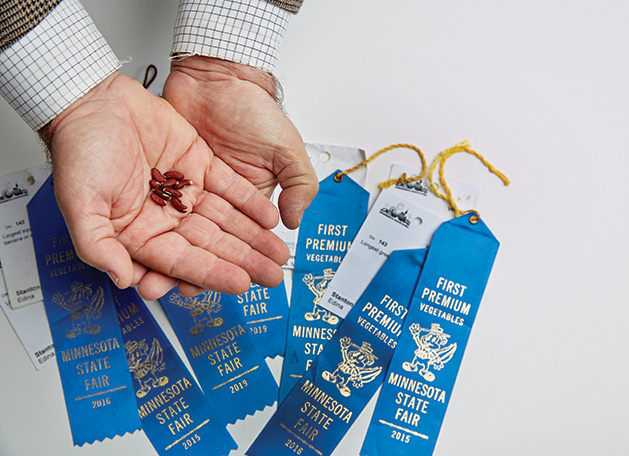 Russell Stanton holds seeds for his Minnesota State Fair blue ribbon-winning squash