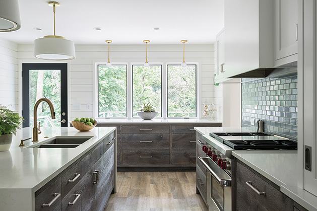 Kitchen design elements in the Nicholson’s home remodel included: Countertops by Caesarstone in “frosty carina;” Wood faced cabinetry made from European live oak, custom stained and white washed; Light fixtures by Rejuvenation and Lumens; Appliances by Sub Zero and Wolf