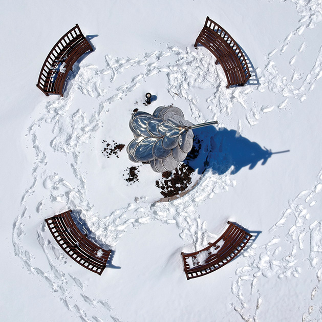 An overhead shot of a sculpture and benches in Centennial Lakes Park in Edina