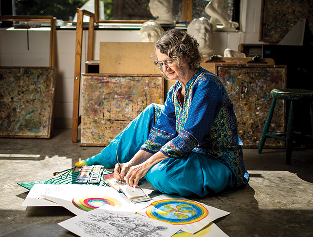 Meditative artist Holly Stone, who teaches classes at the Edina Art Center, works on a painting.