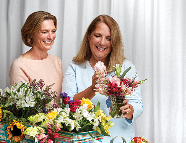 Karen Wooldridge and Laura Hogan of Bluebirds & Blooms prepare a bouquet.