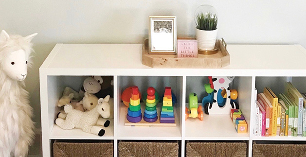 Children's toys sit organized on a set of shelves, thanks to Style + Dwell.