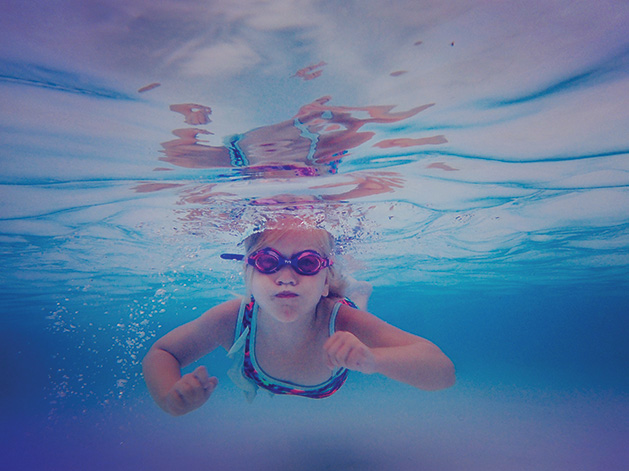 A girl swims underwater at the Edina Pool in Melissa Hunzelman's photograph "Little Fish"