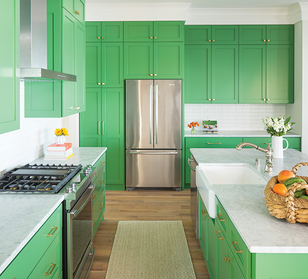 A kitchen renovation by City Homes, featuring quartz countertops and green cabinets.