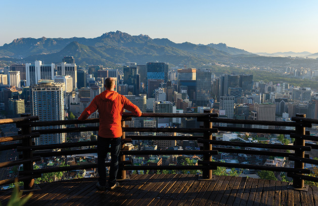 A high school student from an exchange program looks at the skyline in Seoul, South Korea.