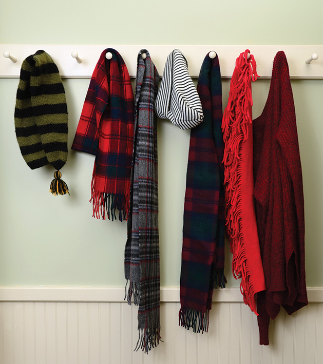 Winter gear like hats and scarves hang on hooks.