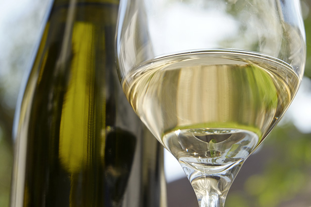 A bottle and glass of Riesling white wine