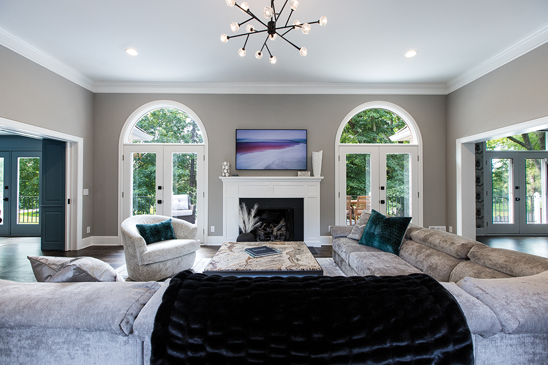 This newly renovated living room is an elegant and bright environment that leads into the den seen above.