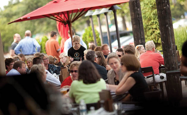 (Left): Diners enjoy a beautiful day on the patio at Tavern on France. (Right): A customer favorite at Tavern on France is the wood-fired pizzas.Photos courtesy of tavern on france; abby andrusko