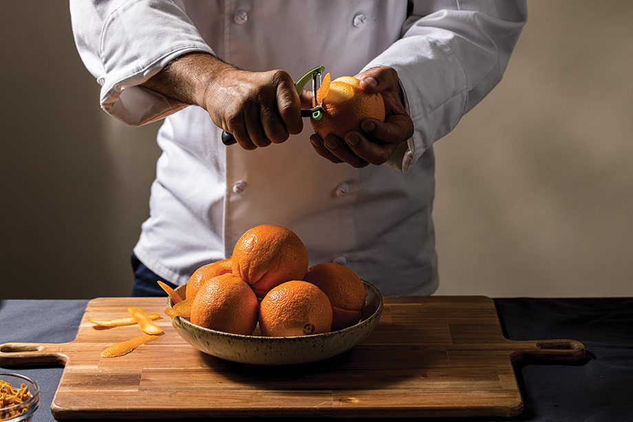 Chef Tom Dokman peeling oranges.