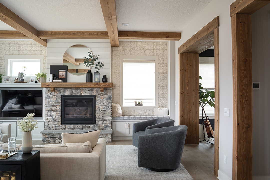 Elegant beams draw the eye to the fireplace which uses the mantel to accentuate a focal point in the room.