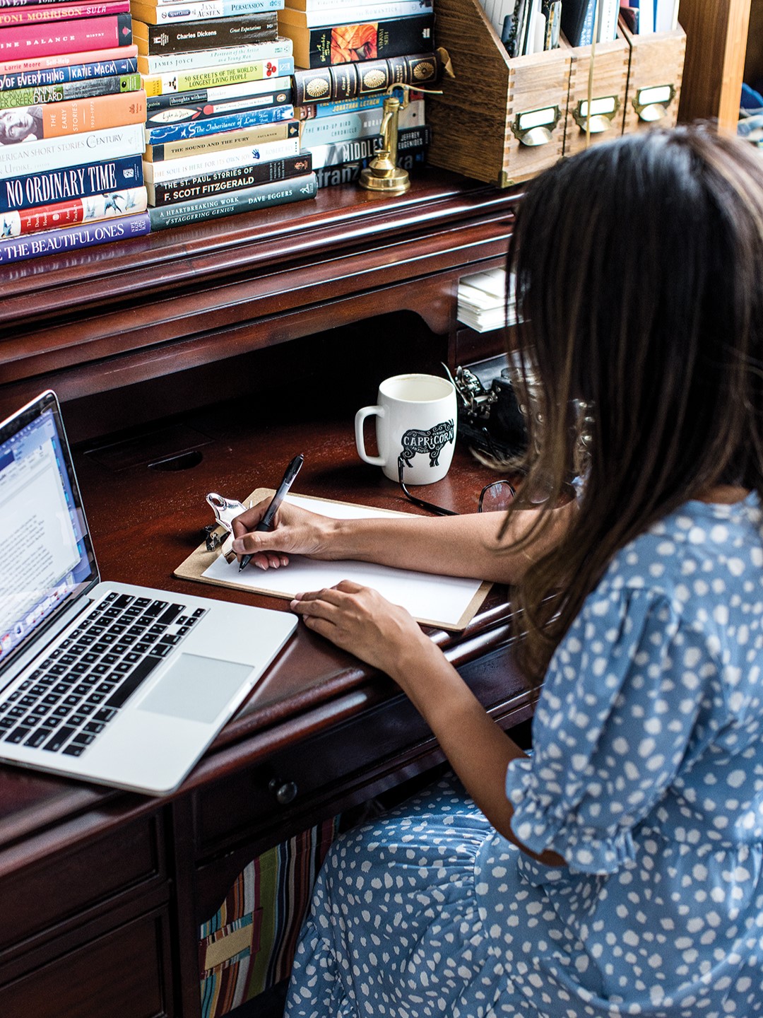 Dixit immerses herself in the creative flow of her home office, penning her latest masterpiece.