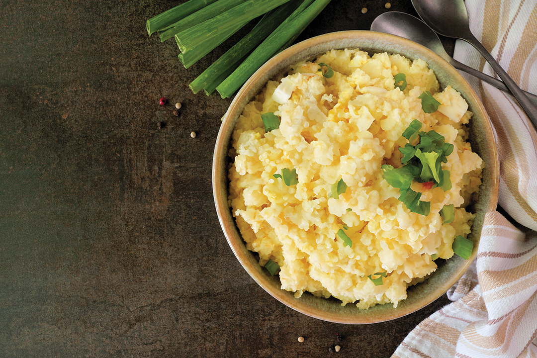 Traditional potato salad. Top down table scene on a dark stone background. Copy space.