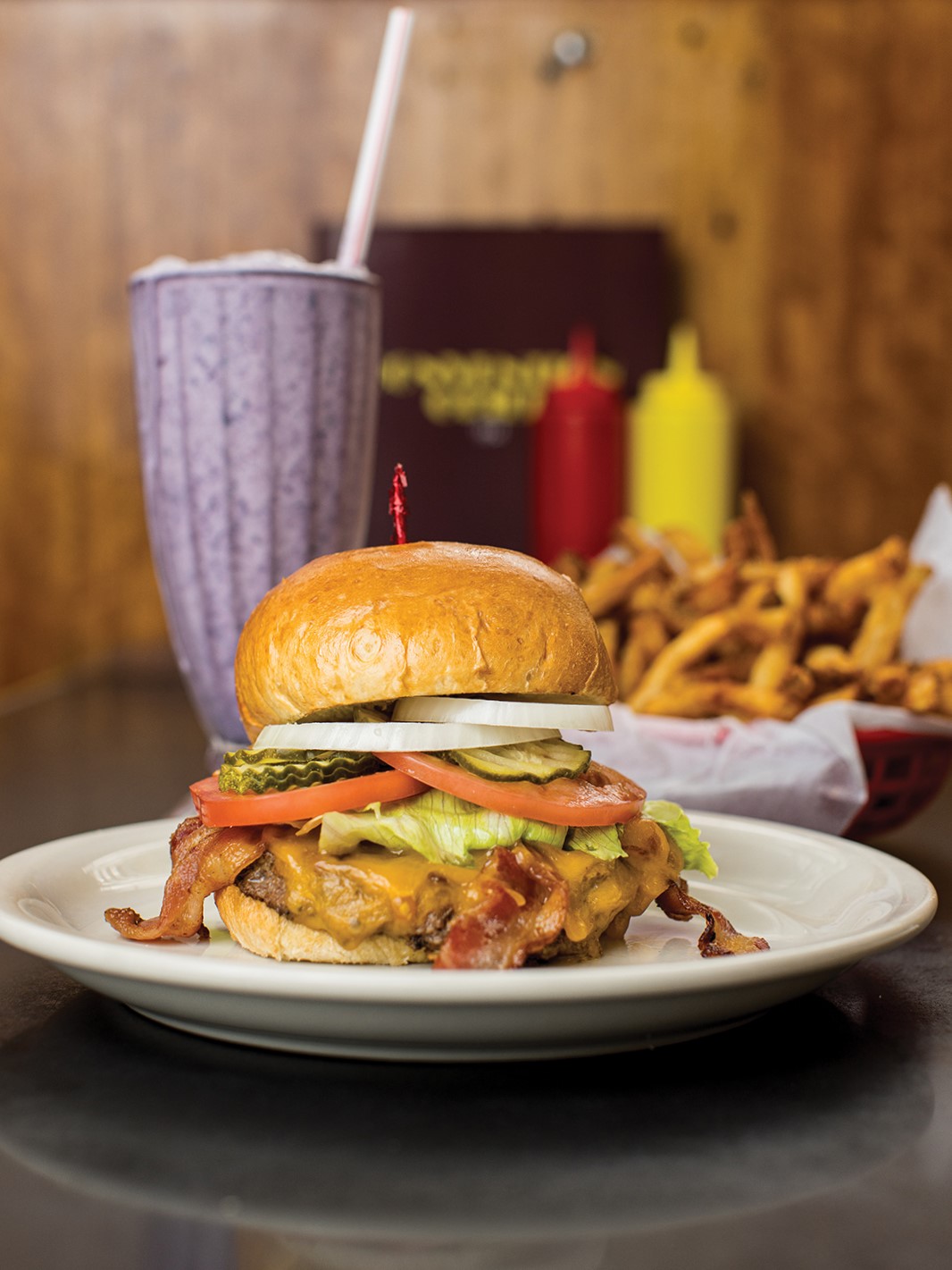 The California Cheeseburger with bacon and a side of fries. Convention Grill is known for its wide variety of malts, such as this Wild Blueberry Malt.