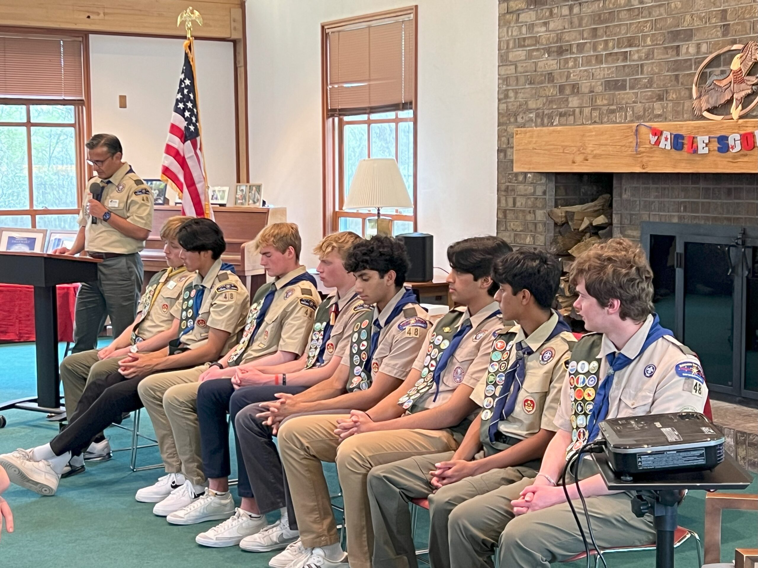 Scouts of Troop 48 sit at the front of the room during the ceremony.