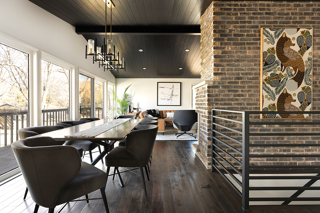 A new, extended light fixture and table draw the eye to length of the area and emphasizes the windows. It also provides a great transition from the dining area to the living room.