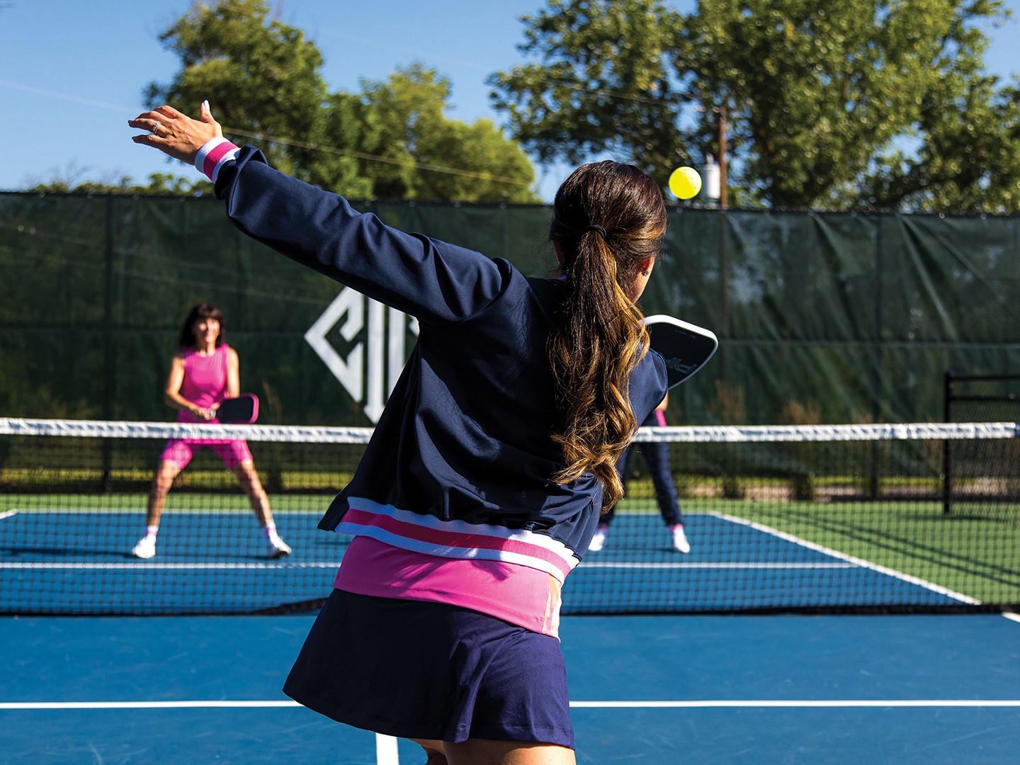 Women playing pickleball wearing Saltie Rose clothing