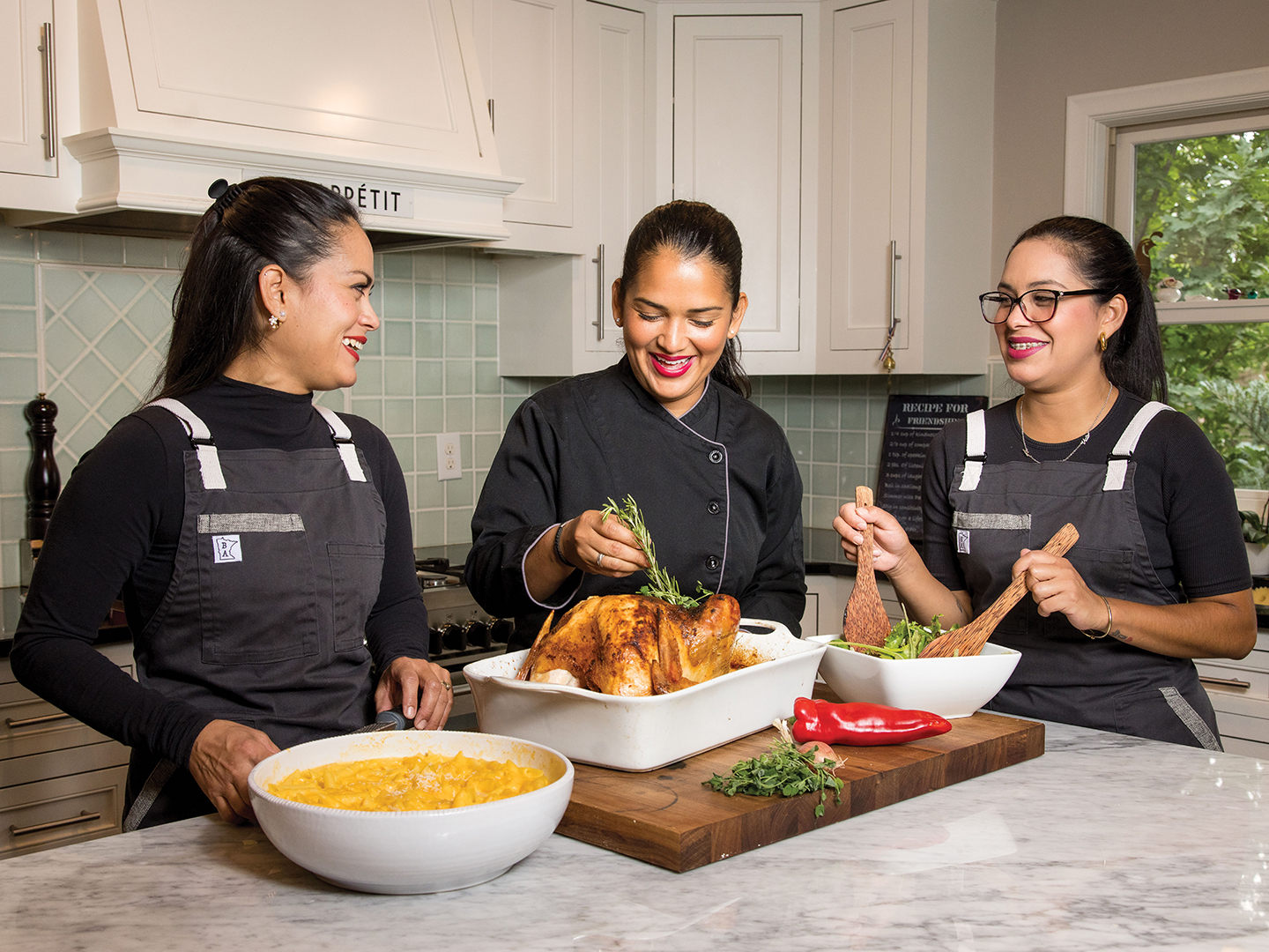 Márquez in the kitchen with her sisters, Gabriela Márquez (left) and Yustin Marioly Márquez (right).