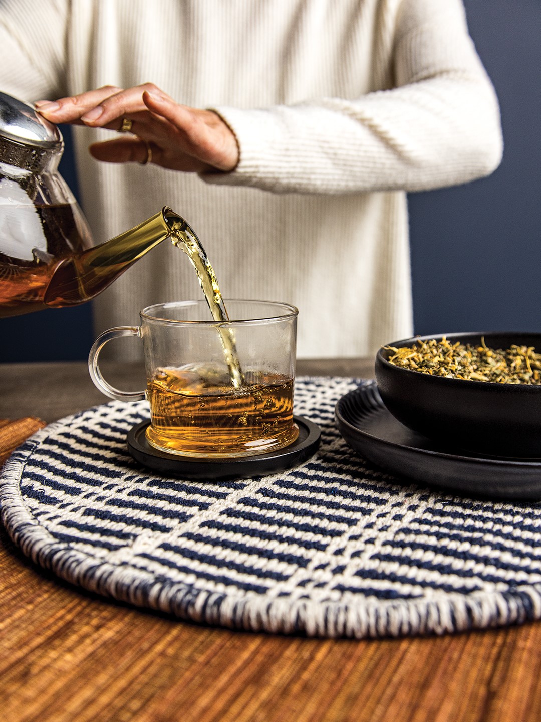 Person Pouring a Cup of Tea