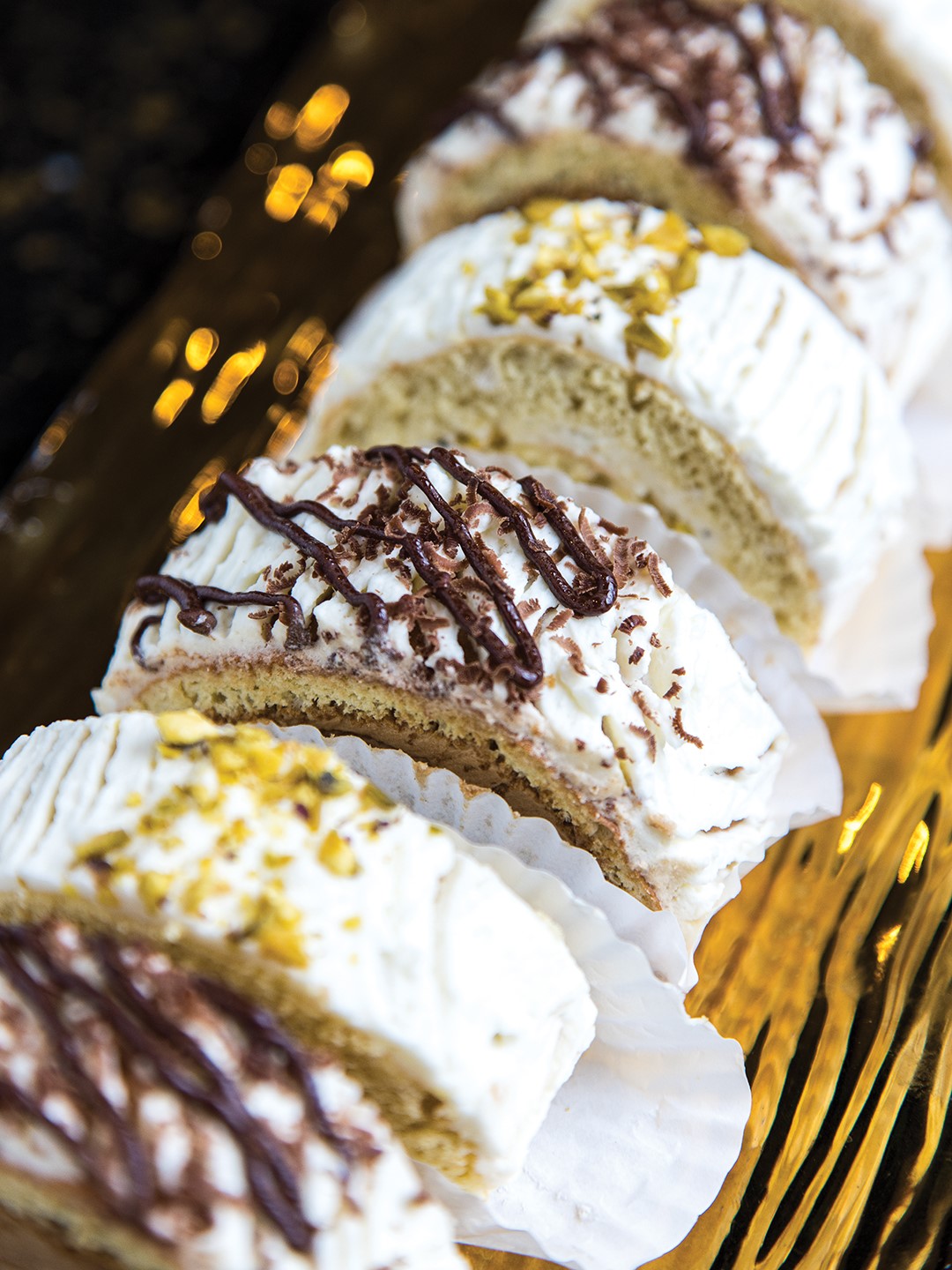 Swiss rolls, in coffee and pistachio flavors. Also known as rollet, roulade and roulette, the light and moist cake has a delicious cream filling.