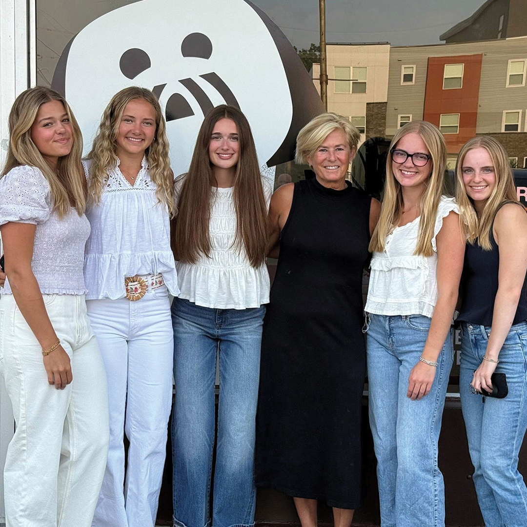 The Luca & the Five Girls team in front of their store at Cahill Avenue and West 70th Street. The logo on the window is a drawing of Luca, the dog who inspired the brand.