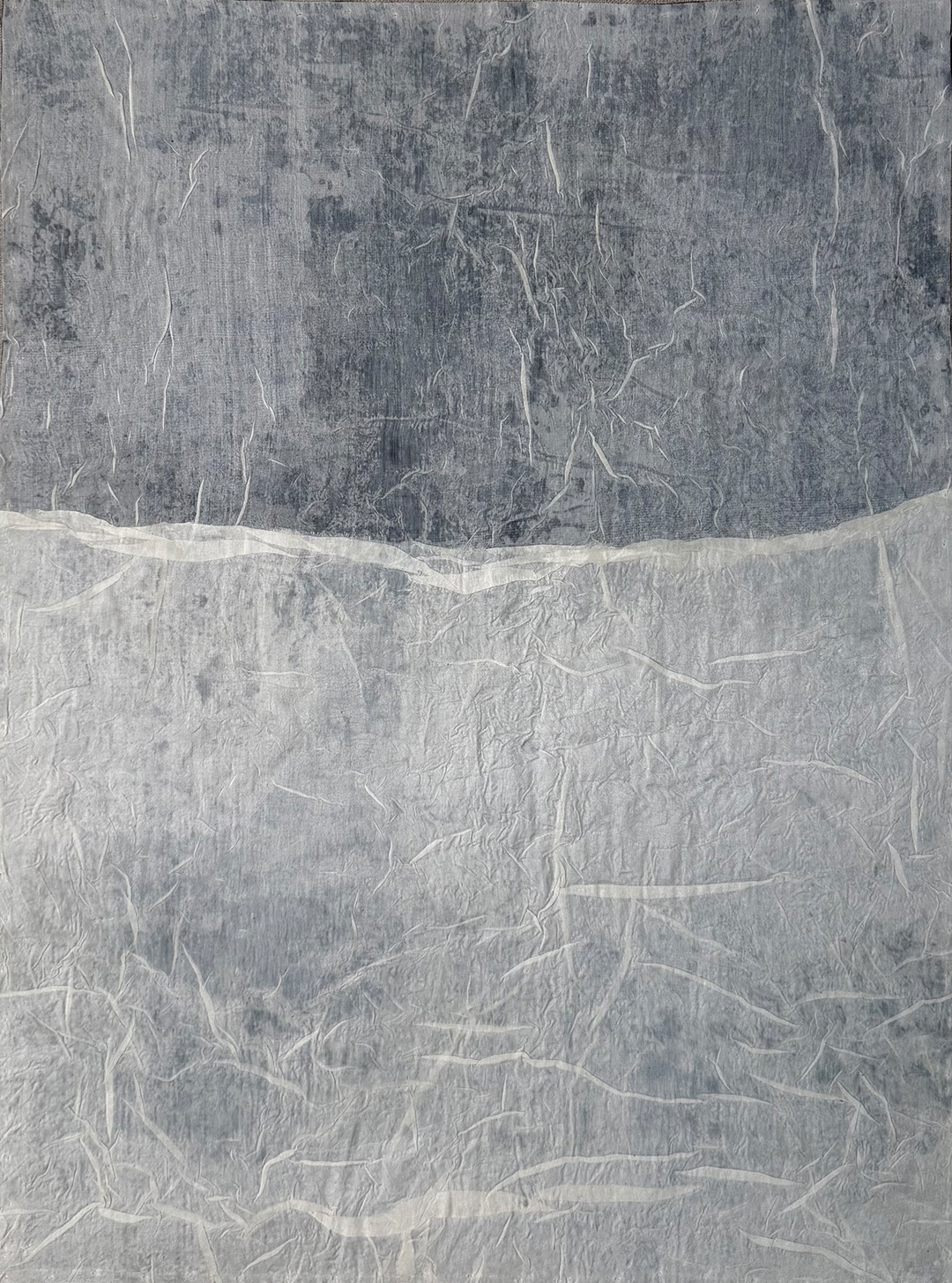 Folded Quiet by Moira Bateman: Mud dye, organic peace silk, flat thread, wax, linen frame; 61cm x 46cm; 2025