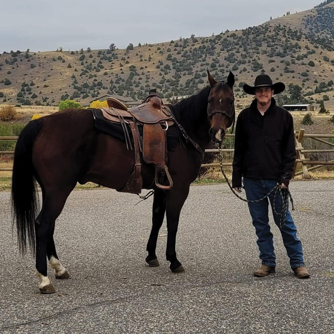 Brian Conroy pauses for a moment with one of the ranch’s horses.