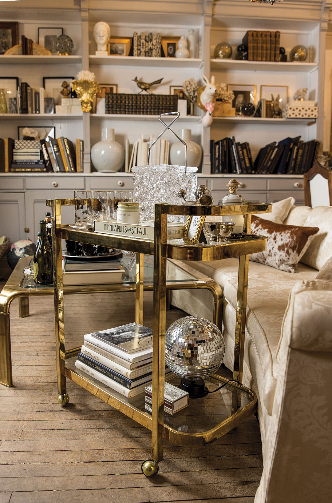 A bar cart complete with a mid-century modern Lucite ice bucket.