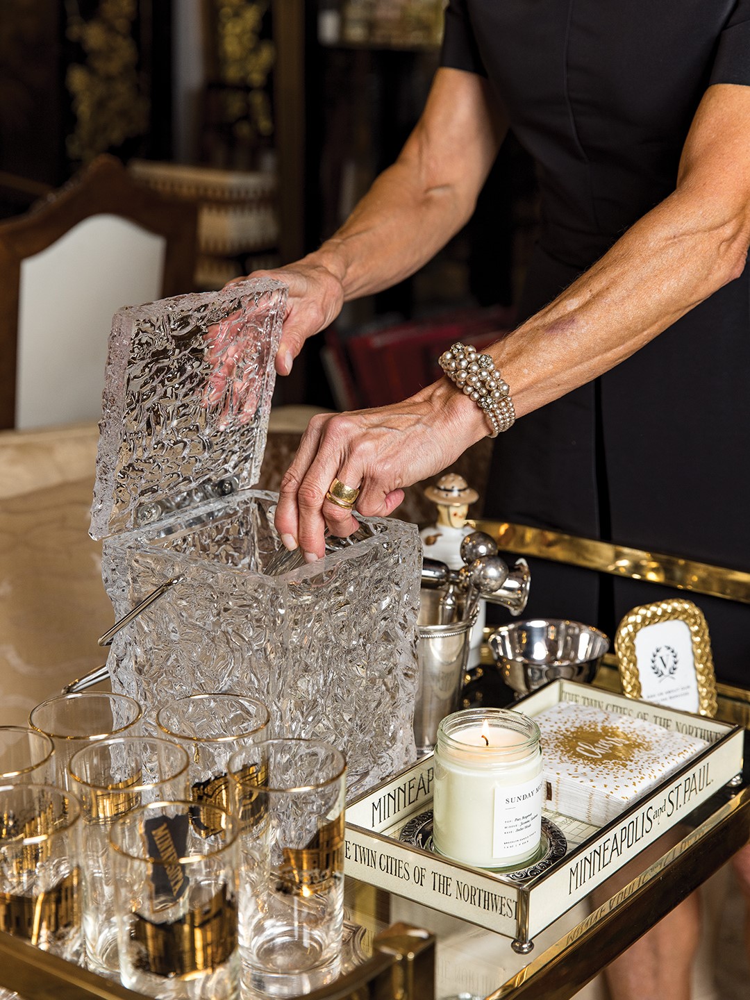 A cherished set of vintage Minneapolis-themed glasses, once given to new bank customers, features gold accents and illustrations of local landmarks. 