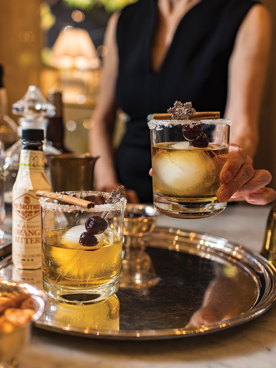 Woman holding a vintage cocktail glass.