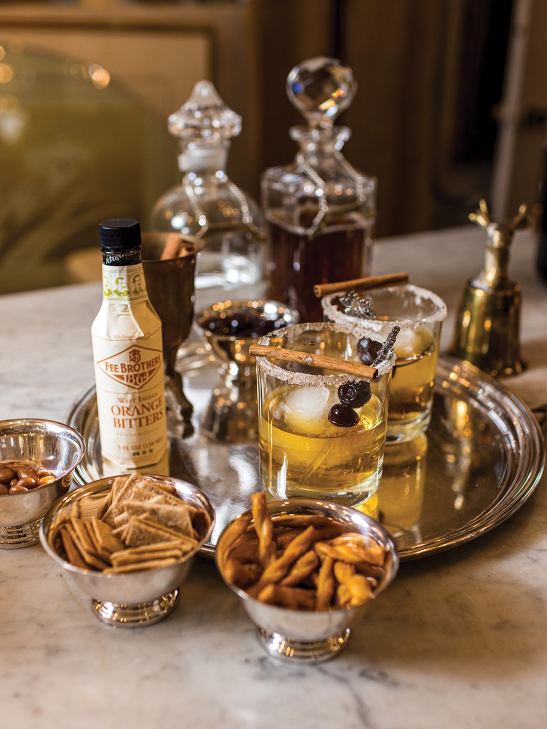 Snacks and holiday cocktails on a silver platter.