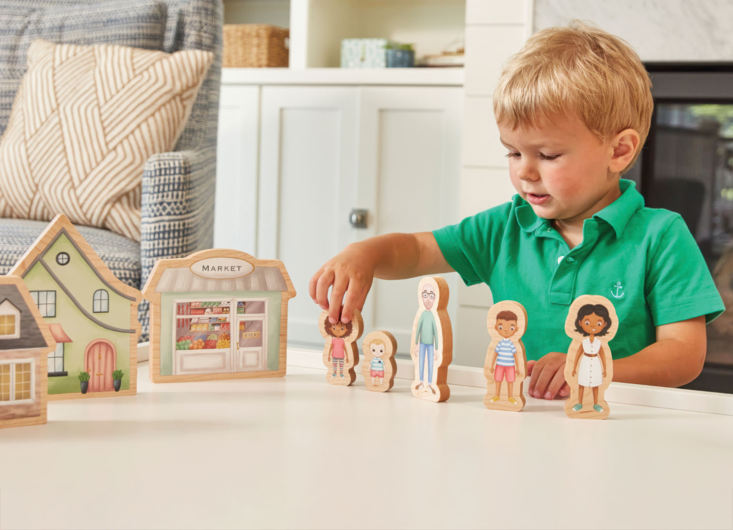 Little boy playing with Kith + Kin Co family dolls