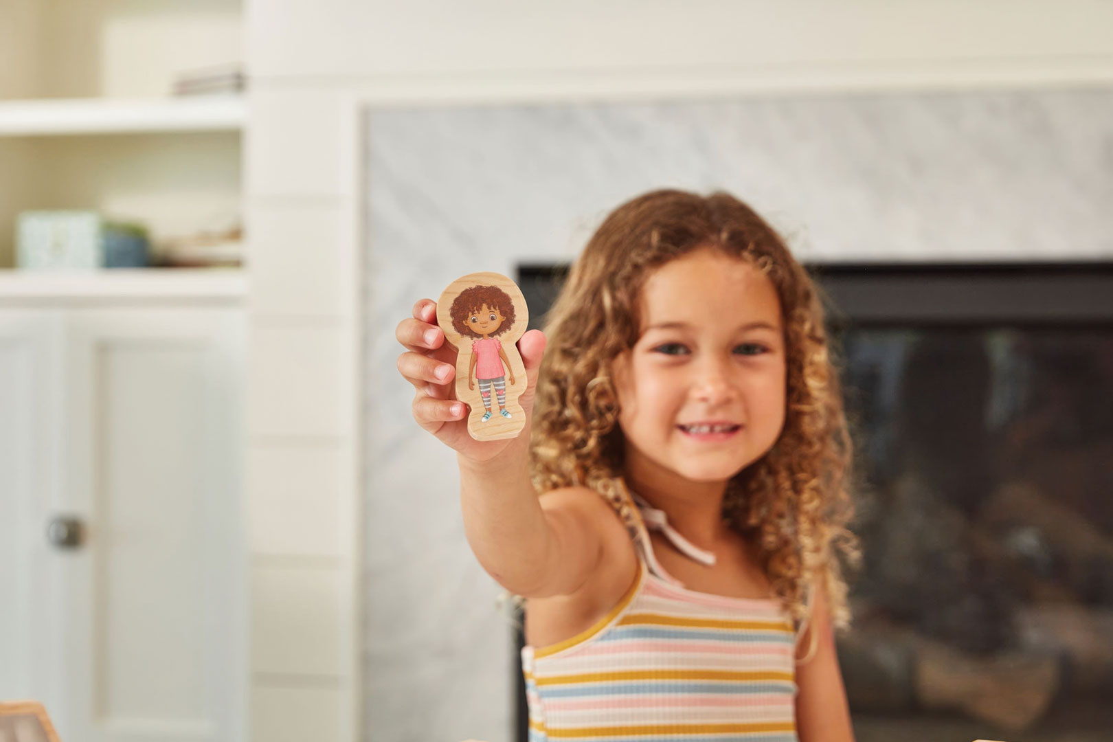 Little girl playing with Kith + Kin Co family dolls