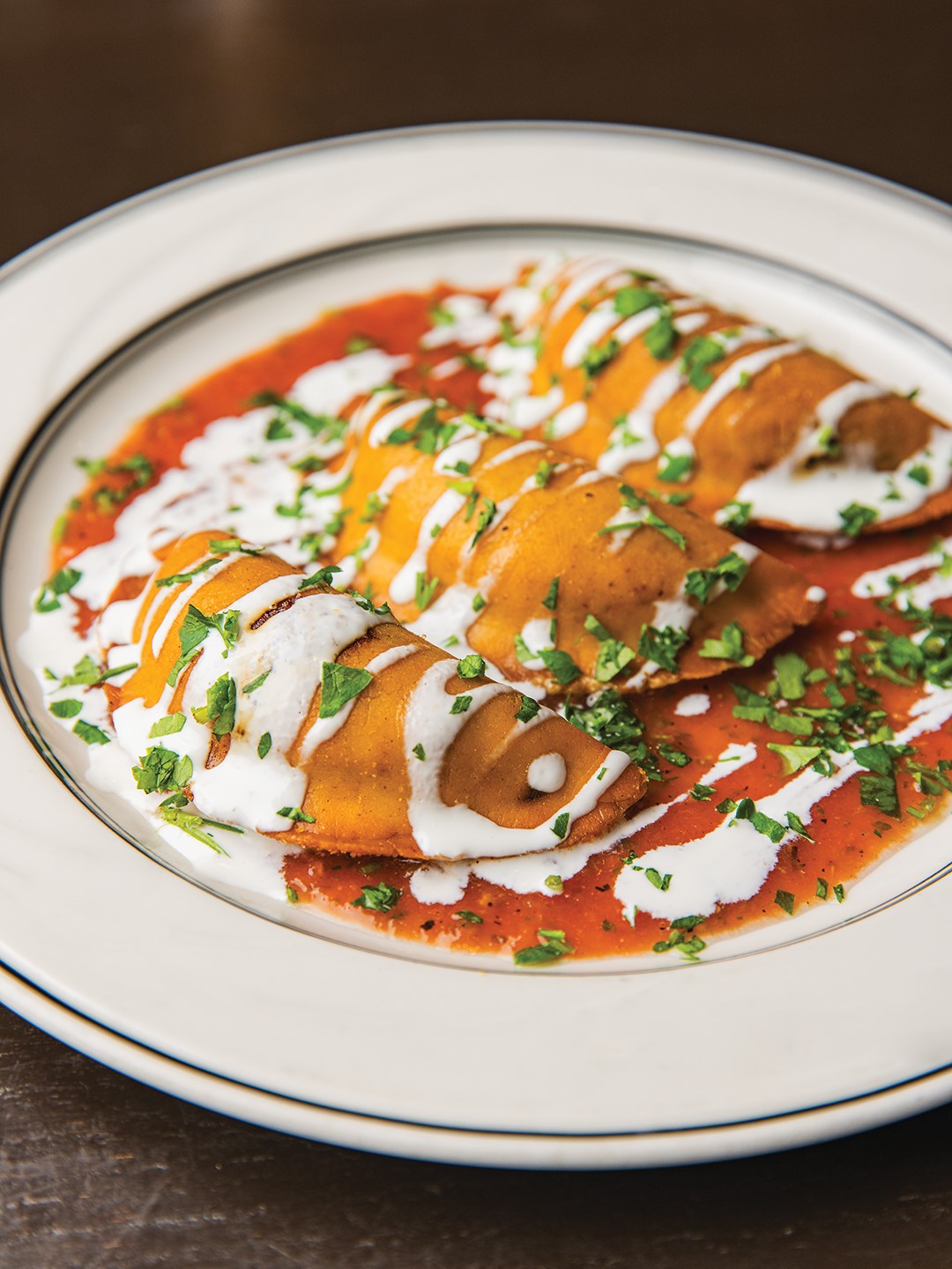 Tucked away in a strip mall in west Edina is Cahill Bistro. Its empanadas are served with crema casera and roasted tomato salsa.