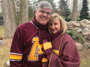 Paul and Jean Mooty. Jean is wearing the Faribault Mill University of Minnesota Throw Blanket.