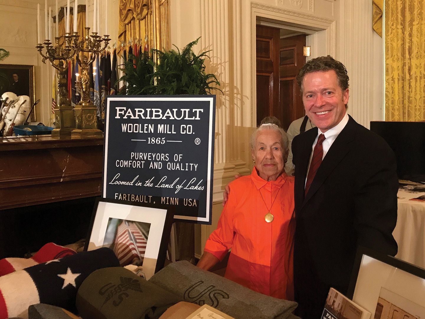 Mary Boudreau worked for the company as a master weaver for decades. When the White House called to invite Faribault Mill to its Made In America Showcase in 2017, Paul Mooty asked Boudreau to attend. She stands beside former CEO Tom Kileen.