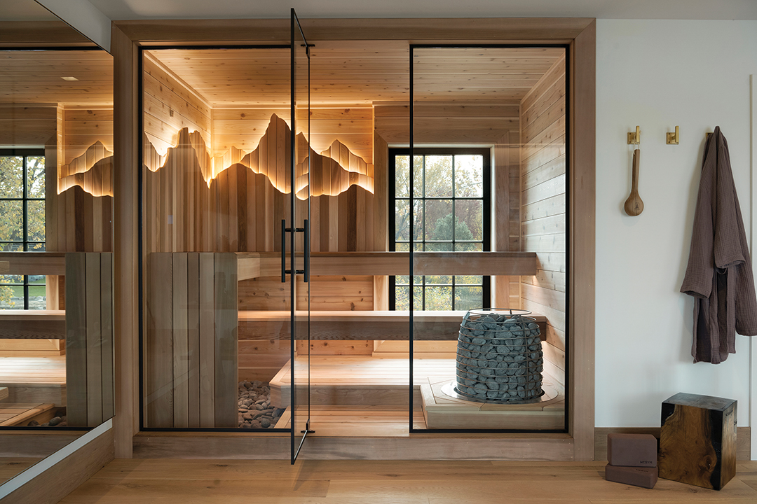 A backlit mountain silhouette brings sculptural dimension to this sauna, demonstrating how architectural lighting can enhance a room’s sense of warmth and retreat. 