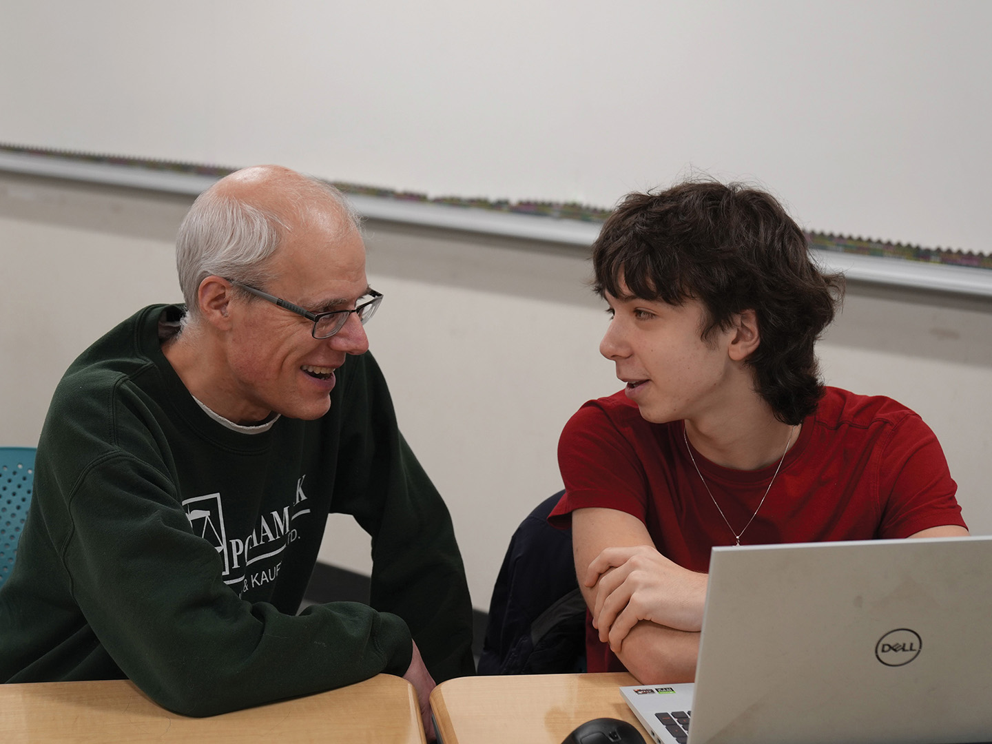Joe Schmitt coaches a student during debate practice at Edina High School.