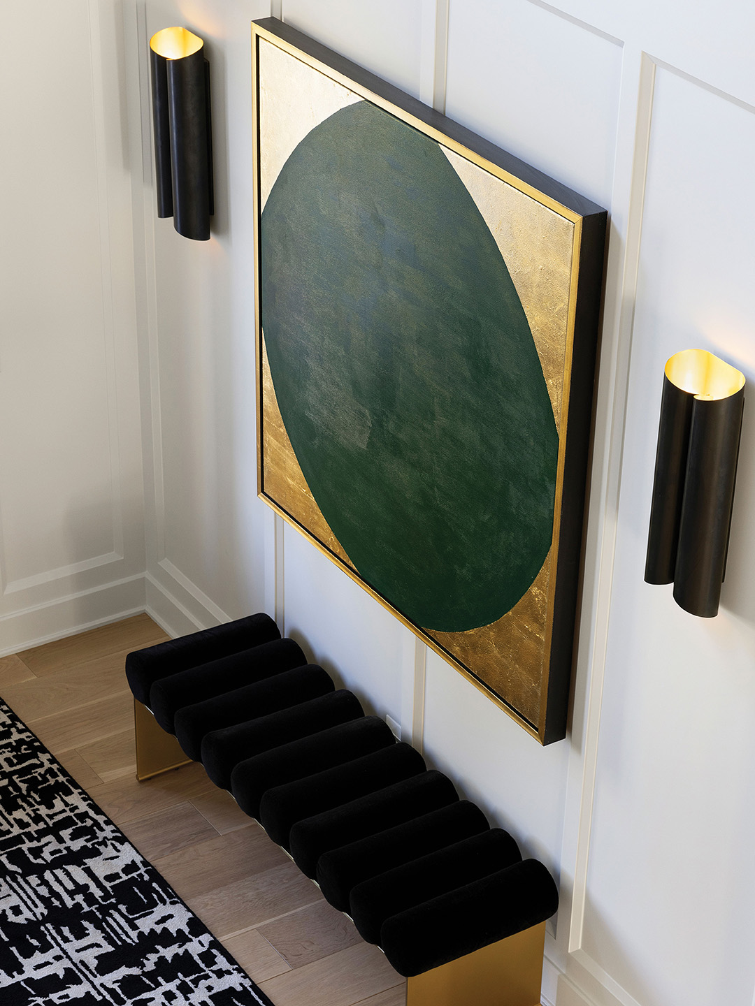 The home’s cohesive and intentional color story continues with Kelly green echoed in the artwork.