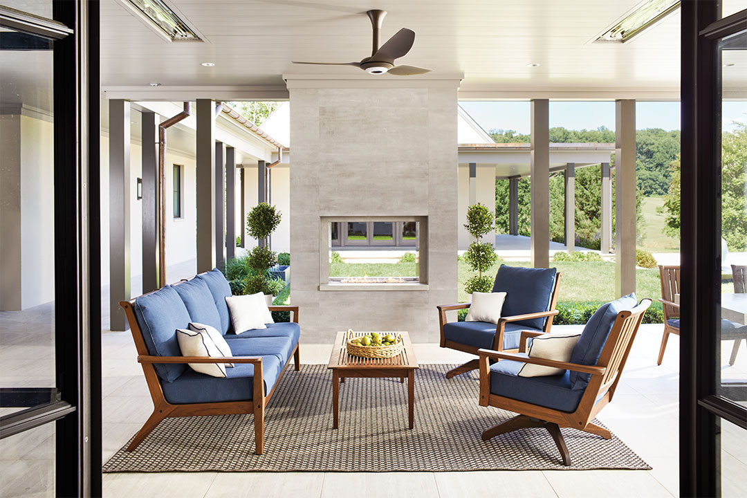 Greg Peterson says the outdoors is an extension of the home. This cozy patio combines comfortable seating with a patterned rug and outdoor fireplace.