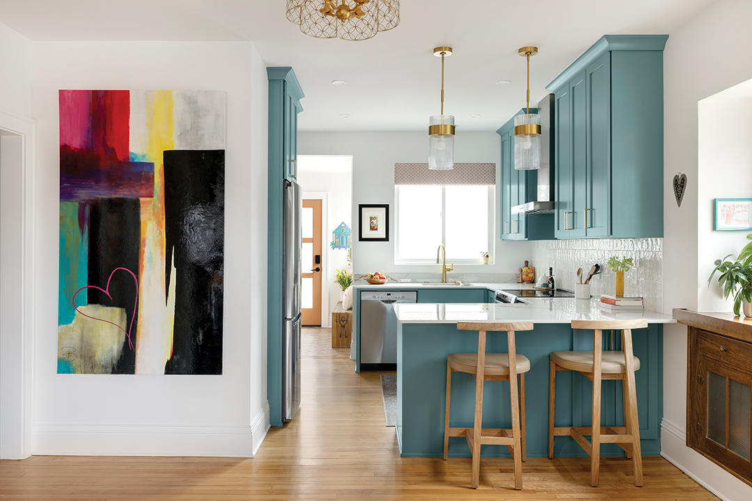 Kitchen with teal cabinets by Zimmer Design