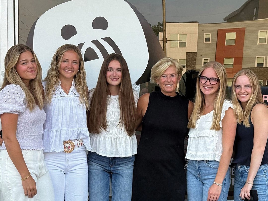 The Luca & the Five Girls team in front of their store at Cahill Avenue and West 70th Street. The logo on the window is a drawing of Luca, the dog who inspired the brand.